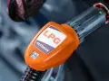 Pomarańczowa końcówka dystrybutora LPG z napisem "AUTOGAS". Rozważasz koszt instalacji gazowej?
