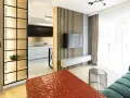 Nowoczesny, bardzo mały salon w bloku z otwartą kuchnią, drewnianymi panelami i designerskimi meblami.
