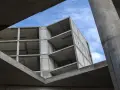 Szkielet budynku z betonu, widok od dołu na niebo. Konstrukcja z betonu, jakby z **styrobetonu**, czeka na wykończenie.