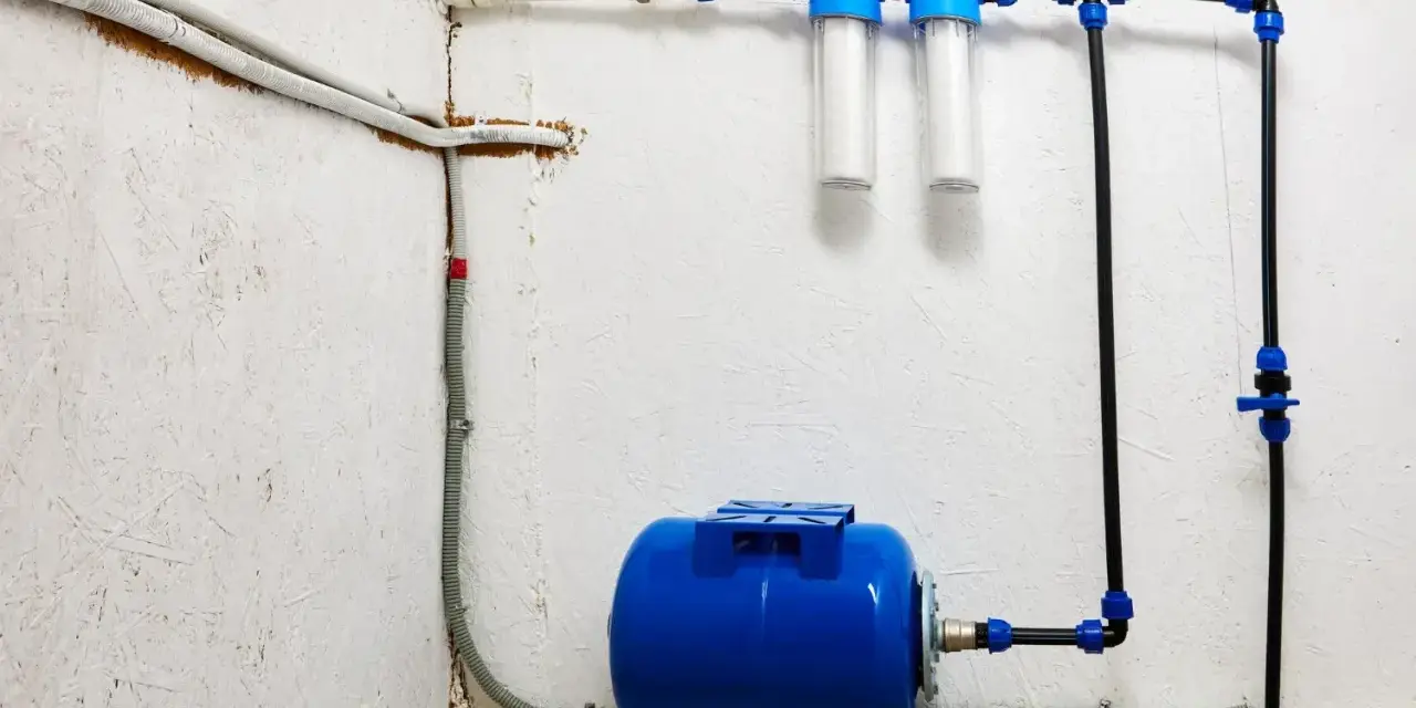 System hydrofornia z niebieskim zbiornikiem, dwoma filtrami wody i instalacją rurową.
